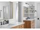 Bathroom with dual sinks, quartz counters, modern faucets, and a decorative mirror at 30455 Telluride Ln, Evergreen, CO 80439