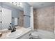 Traditional bathroom featuring a bathtub-shower combination and neutral-toned tiles at 30455 Telluride Ln, Evergreen, CO 80439