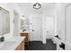 Well-lit bathroom with dual sinks, wood cabinets, and modern fixtures at 30455 Telluride Ln, Evergreen, CO 80439