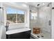 Bright bathroom featuring a modern tub, walk-in shower and large window showcasing a scenic view at 30455 Telluride Ln, Evergreen, CO 80439