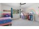 Bright bedroom featuring a pink bed frame, a playful tent, and a colorful rainbow wall decal at 30455 Telluride Ln, Evergreen, CO 80439