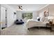 Bright and cozy bedroom with large window, light walls and plush carpet at 30455 Telluride Ln, Evergreen, CO 80439