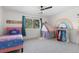 Bright bedroom with a rainbow mural, play tent, and a window offering natural light at 30455 Telluride Ln, Evergreen, CO 80439