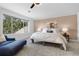 Primary bedroom with large window with backyard views and plush carpeting at 30455 Telluride Ln, Evergreen, CO 80439