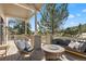Outdoor deck features a fire pit and ample seating with a forest view at 30455 Telluride Ln, Evergreen, CO 80439