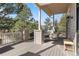 Inviting covered deck with comfortable seating and scenic views of the surrounding trees and landscape at 30455 Telluride Ln, Evergreen, CO 80439