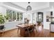 Spacious dining area with a large window, hardwood floors, and view to the living room at 30455 Telluride Ln, Evergreen, CO 80439