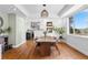 Dining room with hardwood floors, a large window, and stylish lighting fixture at 30455 Telluride Ln, Evergreen, CO 80439