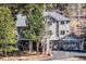 Stunning two-story home with a welcoming facade, featuring a well-manicured lawn and lush trees at 30455 Telluride Ln, Evergreen, CO 80439