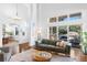 Bright living room with hardwood floors, high ceilings, and sliding doors to the outdoor deck at 30455 Telluride Ln, Evergreen, CO 80439