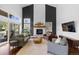 Spacious living room with a soaring ceiling, fireplace, and large windows at 30455 Telluride Ln, Evergreen, CO 80439