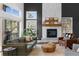 Bright living room features a stone fireplace, modern furnishings and sliding glass door to the outside deck at 30455 Telluride Ln, Evergreen, CO 80439