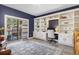 Bright office space featuring built-in shelving and a sliding door to the outdoor deck at 30455 Telluride Ln, Evergreen, CO 80439