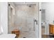 Modern shower with marble tile, glass enclosure, and a built-in bench at 30455 Telluride Ln, Evergreen, CO 80439