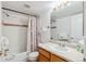Bright bathroom featuring a shower-tub combo with tile surround, a vanity with sink, and neutral decor at 283 Pelican Cir # 1703, Breckenridge, CO 80424