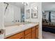 Light-filled bathroom with a mirror, white countertops, and a view into an adjacent bedroom at 283 Pelican Cir # 1703, Breckenridge, CO 80424