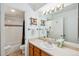 Bright bathroom with white tiling, a mirror with vanity lights, and wood-styled decor at 283 Pelican Cir # 1703, Breckenridge, CO 80424