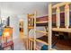 A bedroom with custom wooden bunk beds with a view of the eat-in kitchen at 283 Pelican Cir # 1703, Breckenridge, CO 80424