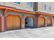 Building 17 with private garages featuring natural wood doors and stained wood trim at 283 Pelican Cir # 1703, Breckenridge, CO 80424