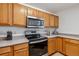 Well-lit kitchen with stainless steel appliances and honey-toned wood cabinetry at 283 Pelican Cir # 1703, Breckenridge, CO 80424