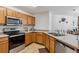 Bright kitchen with stainless steel appliances, tile flooring, and light wood cabinets at 283 Pelican Cir # 1703, Breckenridge, CO 80424