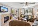 Bright living room with large windows, a cozy fireplace, and comfortable seating at 283 Pelican Cir # 1703, Breckenridge, CO 80424