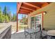 Covered patio with outdoor seating, a grill, and views of the surrounding trees and landscape at 283 Pelican Cir # 1703, Breckenridge, CO 80424