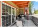 Covered patio with patio table, grill and access to the building via the sliding glass door at 283 Pelican Cir # 1703, Breckenridge, CO 80424