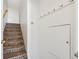 Carpeted stairwell with white walls, hand rail, and coat hooks at 283 Pelican Cir # 1703, Breckenridge, CO 80424
