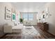 Bright living room has contemporary decor, stylish furniture, and a large area rug on top of wood floors at 6940 Merseyside Ln, Castle Pines, CO 80108