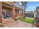 Charming brick patio and backyard with artificial turf and a wooden deck at 821 S High St, Denver, CO 80209