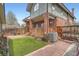 Backyard with covered deck, artificial turf, and access to the exterior at 821 S High St, Denver, CO 80209