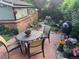 Backyard garden with flowers, brick patio, and seating area at 821 S High St, Denver, CO 80209