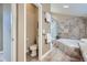Bathroom featuring tiled walls, separate shower and tub with a glass enclosure at 821 S High St, Denver, CO 80209