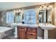 Bathroom with double sinks, tiled floors, ample counter space, and a separate tub at 821 S High St, Denver, CO 80209