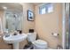 Half-bathroom with modern sink, toilet, and a framed decorative picture at 821 S High St, Denver, CO 80209