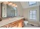 Well-lit bathroom with vanity, tile countertop, and a glass-enclosed shower at 821 S High St, Denver, CO 80209