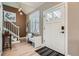 Welcoming entryway with stylish light fixture, wood floors, bench seat, and staircase at 821 S High St, Denver, CO 80209