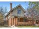 Charming two-story brick home with inviting front porch and landscaped front yard at 821 S High St, Denver, CO 80209