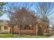 Charming brick two-story home with a mature tree in the front yard and well-maintained landscaping at 821 S High St, Denver, CO 80209