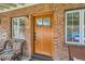 Inviting front entry with a beautiful wood door, sidelight windows, and a cozy seating area at 821 S High St, Denver, CO 80209