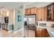Well-lit kitchen area featuring stainless steel refrigerator and wooden cabinets at 821 S High St, Denver, CO 80209