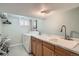 Basement laundry area with washer, dryer, cabinetry, and a large sink at 821 S High St, Denver, CO 80209