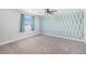 Spacious bedroom featuring stylish wallpaper, carpet, and a ceiling fan at 1923 Ensenada Ct, Aurora, CO 80011
