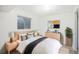 Nicely furnished bedroom features natural wood decor and a small window at 1923 Ensenada Ct, Aurora, CO 80011