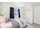 Cozy bedroom featuring a comfortable bed, sliding closet doors and window at 1923 Ensenada Ct, Aurora, CO 80011
