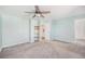 Large bedroom features carpeted floors, ceiling fan, and access to closet and bathroom at 1923 Ensenada Ct, Aurora, CO 80011