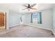 Bright bedroom with carpet, ceiling fan, with windows and access to additional room at 1923 Ensenada Ct, Aurora, CO 80011