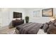 Cozy bedroom featuring modern decor, flooring, and a dresser with television at 1923 Ensenada Ct, Aurora, CO 80011