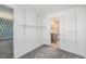 Walk-in closet with shelving and access to the renovated bathroom at 1923 Ensenada Ct, Aurora, CO 80011